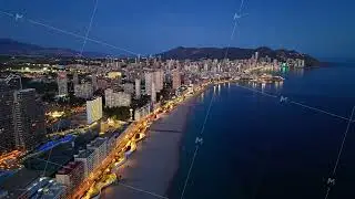 Bright Urban Shoreline Under Tranquil Evening Sky, Serene City Lights Reflect On Calm Waters At