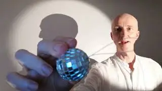 A seal balancing a ball on its nose in hand shadows