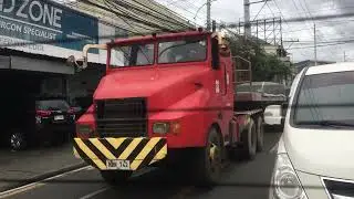 33 Red and Yellow American REO Tractor Head with Light Red Trailer Bed in Congressional Ave.