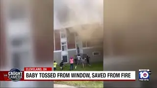 Video shows mother tossing baby out apartment window after fire, explosion
