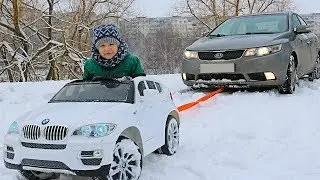 FUNNY BABY Stuck in the SNOW! Kid ride on POWER WHEEL Towing car BMW Funny cars video for kids