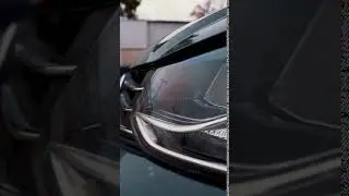 Close up of details of headlights of anonymous prestigious luxury modern car. Action. Vertical view