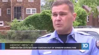 Firefighter catches baby thrown out of window during fire