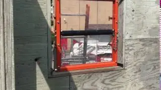 Taking the glass with the tip of a portable ladder.