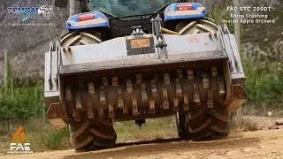 FAE STC200DT PTO stone crusher machine behind New Holland tractor crushing rocks in apple orchards