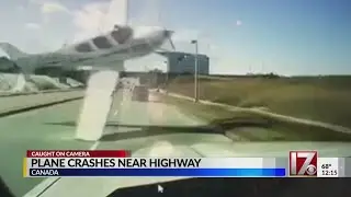 Plane crashes in front of car in Canada