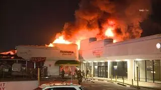 Los Angeles City firefighters battle a strip mall fire in Koreatown, Los Angeles, California.