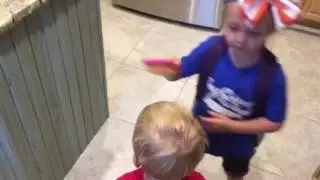 Kimbrey combs her brothers hair