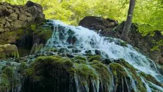 Waterfall flows from Yusupov lake. Spring. Mountain Crimea. 4K