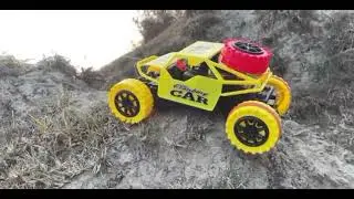 Monster car, truck and JCB play toys near lake