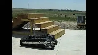 Stair climbing with shape changing tracks on a mobile robot.