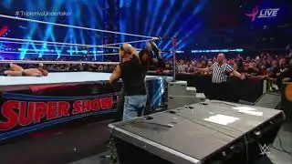 Undertaker chokeslams Shawn Michaels through a table at WWE Super Showdown