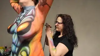 Stunning UV airbrush bodypaint of luscious model