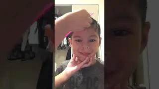 Sister combing her little brother’s hair with his crazy expressions
