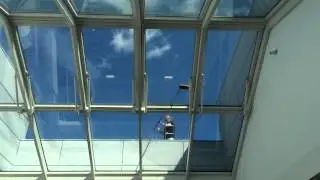 Atrium glass cleaning in Frimley - Back pack on roof & ladder footed.