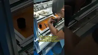 He is installing screws for the panel light assembly line equipment.