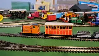 Bachmann Rusty Pulling 1 red  coach, 2 grey slate wagons and blue brakvan