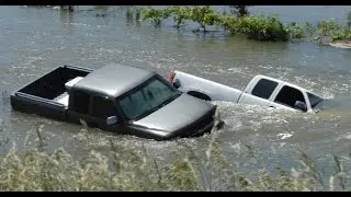Guy FAILS Driving Thru Water Over Road