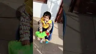 &ldquo;Sunshine baby with her green friend 🌞🦜 #parrotlove # nature baby #youtubeshorts #viralbaby