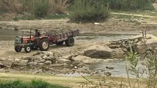 Tractor Offroad with fully loaded in water crossing