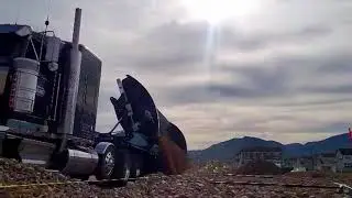 Side Dump trailer windrowing material.