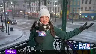 Snow falls on Canal Street