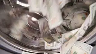 United States Paper Dollars spinning inside a washing machine, slo-mo