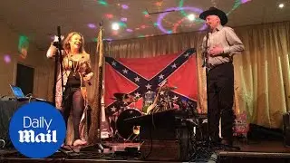 Bruce Jones performs on stage in front of Confederate flag - Daily Mail