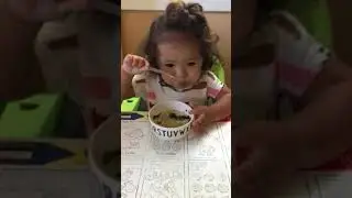 Happy baby dancing while eating