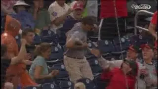 Baseball fan saves wife from flying bat. Gets kiss