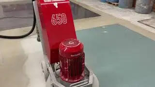 Concrete Grinder and Vaccum taking off Quarts Flooring