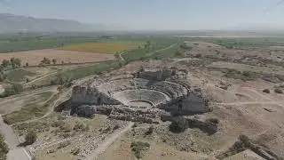 D-Log M. Balat, Turkey. Panoramic drone view over Miletus Theatre and its landscape with green fi...