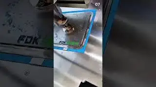 Machining metal surface with industrial press near warning label