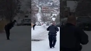 Police car slides down icy road, crashes into parked vehicles