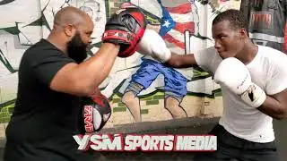 Slick Southpaw Ismail Muhammad does pads with trainer Derek 