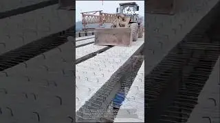 Moving bridge segments: loader at work