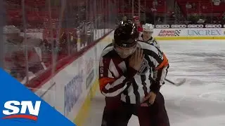 Brett Pesce Nails Referee With Puck On Clearing Attempt