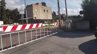 Hitachi EMU passes Via del mare railroad crossing in Zappulla Sicily Italy
