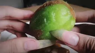 Peeling off kiwi with long nails