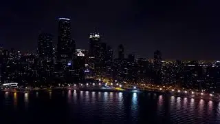 4K drone video of Downtown Chicago at Oak Street Beach at night