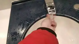 Unbranded basin with push button hand dryer at metrocentre shopping centre in metrocentre