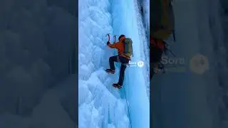 A person climbing an iceberg