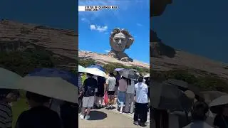 Beneath the towering statue of Chairman Mao in Hunan!