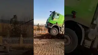 Truck stuck in mud, another truck comes to rescue