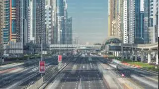 Busy Sheikh Zayed Road timelapse, metro railway and modern skyscrapers around in luxury Dubai city