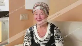 Woman aged looking into the camera and talking on the video link. She smiles and asks about your