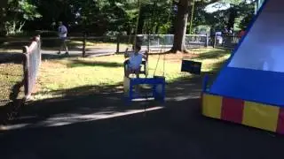 Bella rides the kiddie swing ride