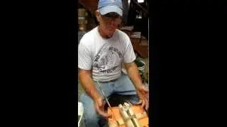 Finishing the core drilling of a bannerstone.