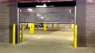 Perforated see through parking lot garage door.