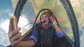 Posh girl looses her hair out the window during aerobatics
